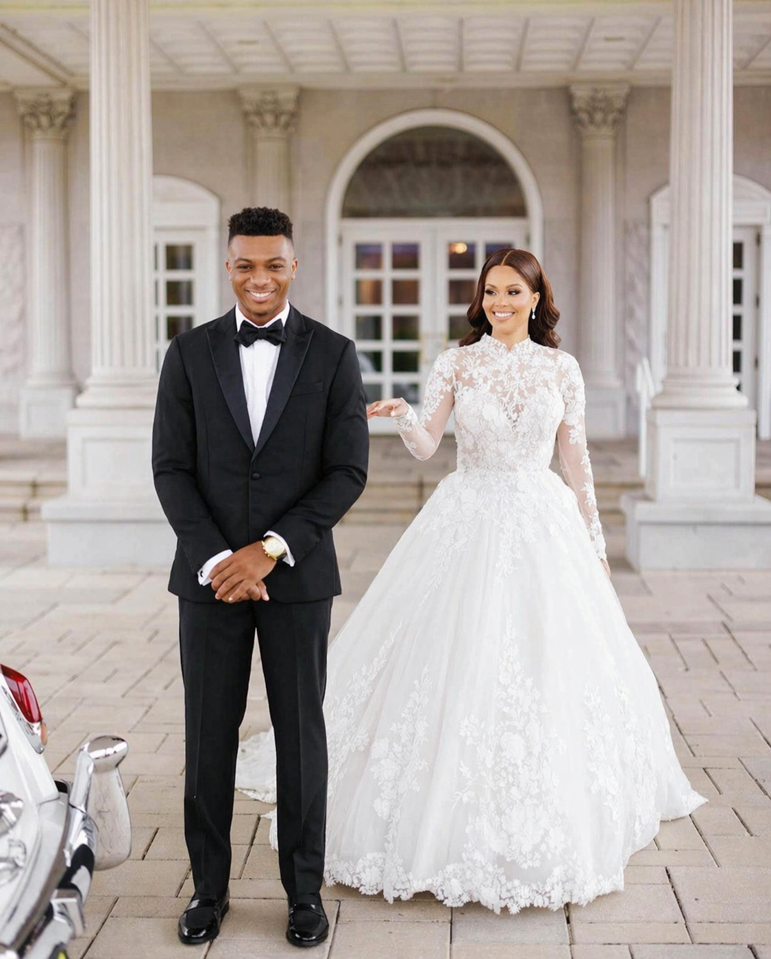 Bride and groom in custom tailoring at marble portico