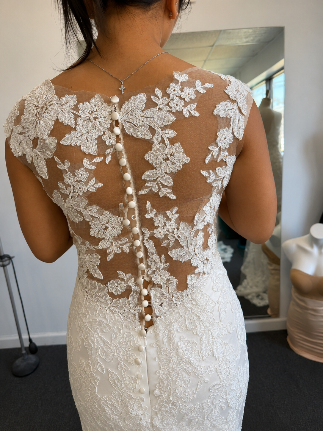 Hand-finished lace back with covered buttons on a bridal gown